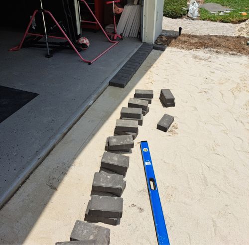 A blue ruler laying on top of a sandy beach