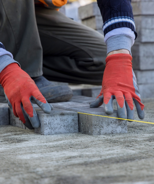 A person wearing red gloves and orange gloves