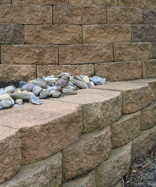 A pile of rocks sitting on top of a stone wall