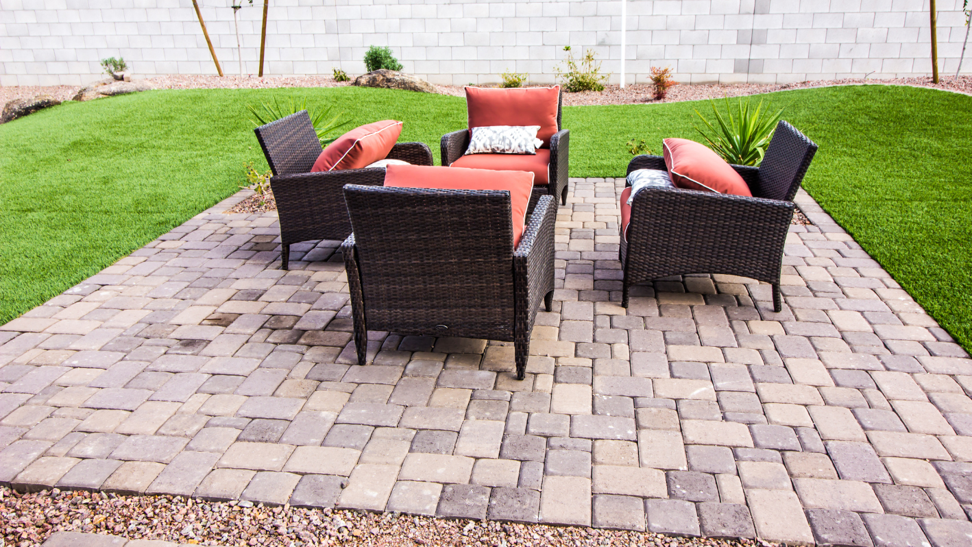 A patio with chairs and a fire pit